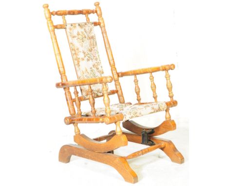 A 19th century children's beech American boston rocking chair. The chair having a turned oak frame with spindles to armrests 