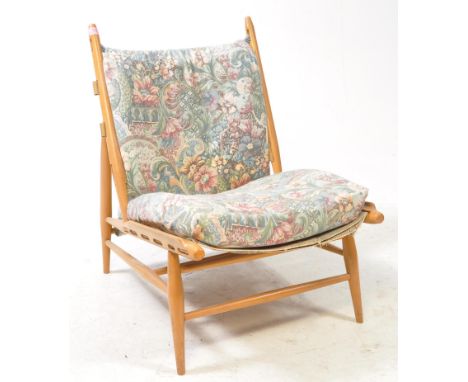 Lucian Ercolani for Ercol Furniture - Ercol model 427 easy chair. Show wood beech frame with webbed seat and back rest with c