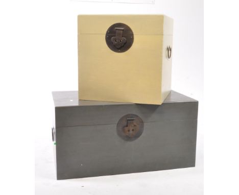 Two Chinese 20th century grey and cream storage / blanket box trunk chests. Square form with ebonised metal hinge clasps and 