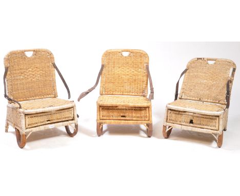 Three vintage 20th century wicker folding canoe picnic hamper chairs. With leather lined handles, folding backrest and cane w