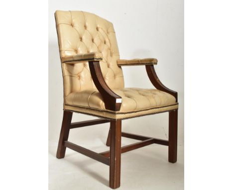 A 20th century Mahogany and cream leather Gainsborough style armchair. Raised on squared legs with button backed cream leathe