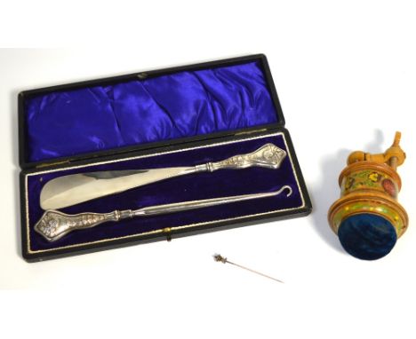 A boxed hallmarked silver shoe horn and button hook set, marks rubbed, a yellow metal stick pin, and a Victorian treen pin cu