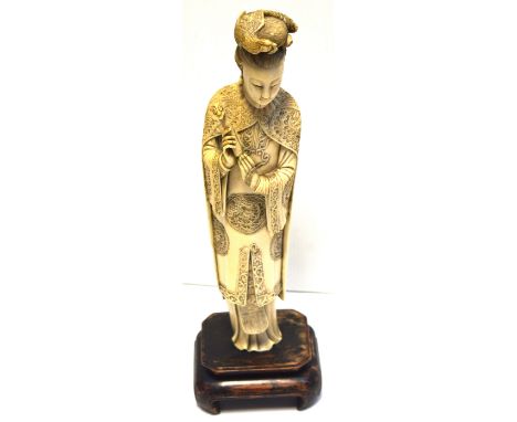 A late 19th early 20th century Chinese ivory carved figurine of a lady with heavily carved cloak and costume holding a Rui sc