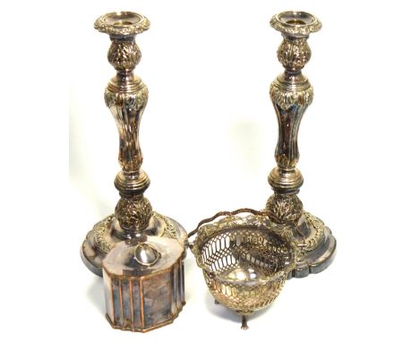 A pair of silver plated candlesticks, height 34cm, a silver plated tea caddy and a pierced silver plated basket on paw feet (