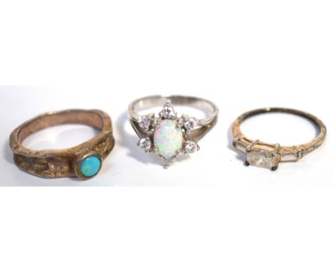 Three silver 925 dress rings, one set with opal and white stones, one with white stones and one with small turquoise stones.