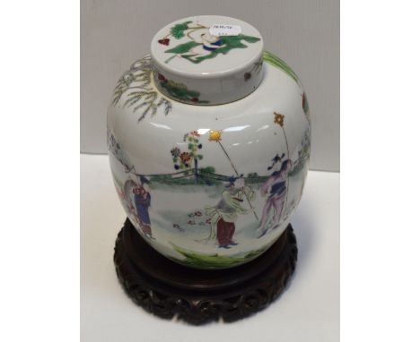 A late 19th early 20th century Oriental ginger jar with cover in the famille verte palette decorated with family figures and 