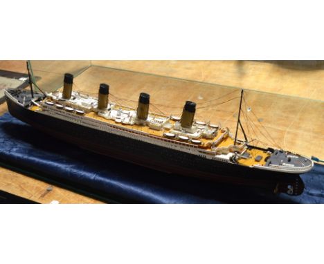 A kit built scale model of the Titanic in perspex case, length including case 92cm.