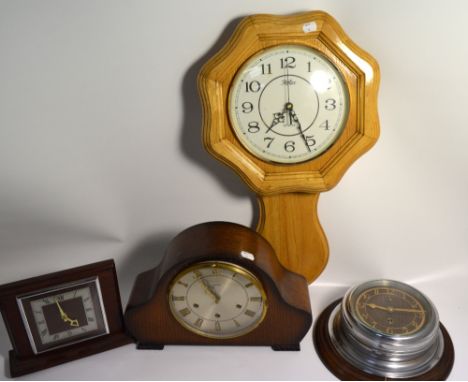 A mid 20th century Smiths oak cased mantel clock, silvered dial set with gilt Roman numerals, an unnamed oak cased mantel clo