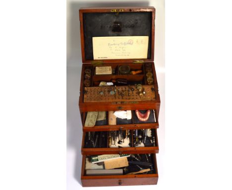 An early 20th century six drawer mahogany dentist portable cabinet complete with dentists tools and drills, various phials, d