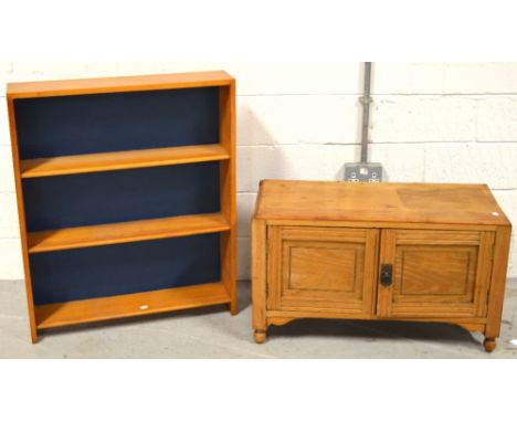 A small modern pine cupboard with two doors on ball feet, 50 x 60xm and a modern pine three shelf bookcase, 90 x 78cm (2).
