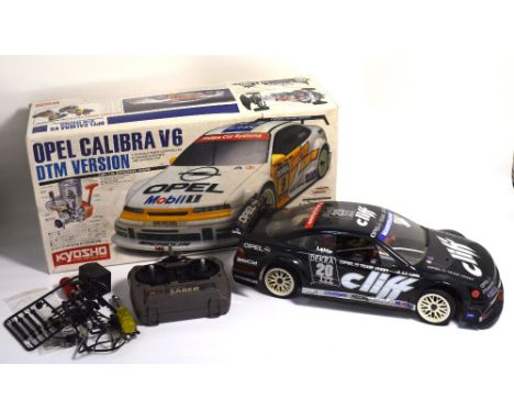 A boxed 1/10th scale Kyosho model of a DTM Opel Calibra touring car from the "Pure Ten" series. Fitted with a pull-start glow