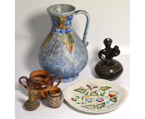 A large Cranston pottery Art Deco style blue mottled ground jug, a Royal Doulton stone glaze loving cup, a small Doulton lace