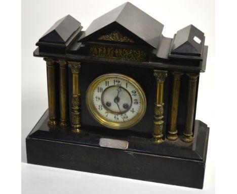 A late 19th early 20th century slate mantel clock, dial set with Arabic numerals flanked by gilt heightened columns, with sil