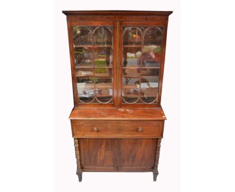 A George III mahogany secretaire bookcase, the upper twin door astragal glazed section above one long drawer and two cupboard