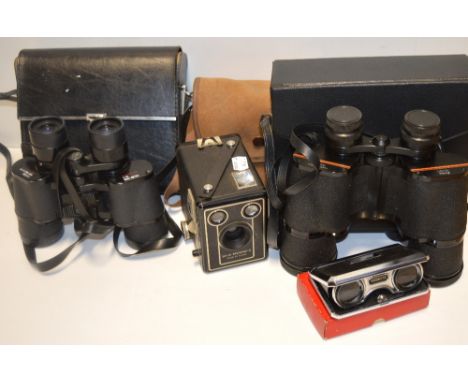A pair of Prinz 10 x 50 binoculars, a pair of Falcon zoom binoculars in case, a boxed pair of 20th century folding opera glas