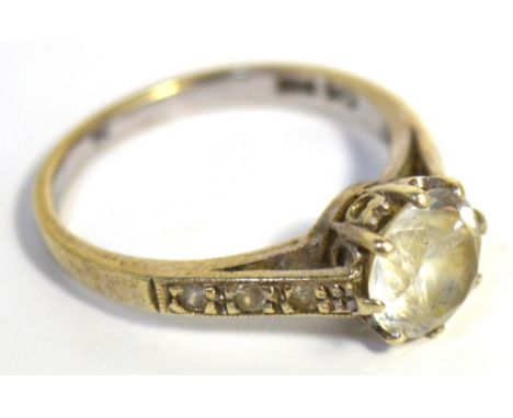 A 9ct gold ring set with a central white stone and three small white stones either side.