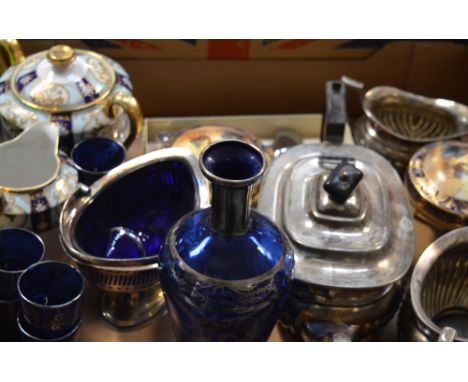 A three piece silver plated tea service, a small quantity of Noritake to include pots and covers, a jug, a cobalt blue glass 