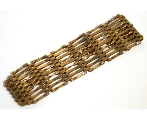 A 9ct gold nine bar gate bracelet with padlock and chain fastener, approx 15.6g.