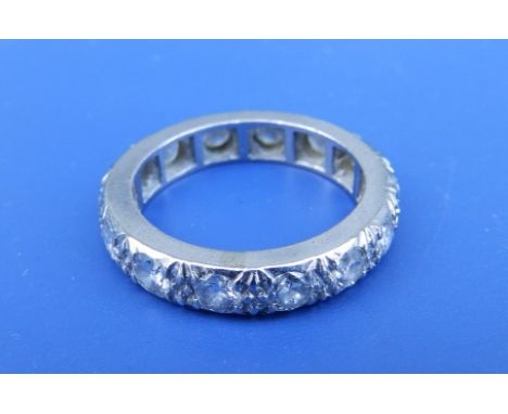 A diamond set white metal eternity ring having 14 brilliant cut stones of total weight approximately 1.5 carats.  Finger size
