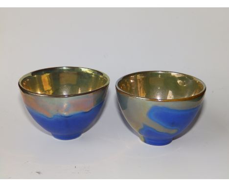 A pair of small silver lustre studio pottery bowls , the lustre interiors dripping over onto bright blue matt exteriors - MCA
