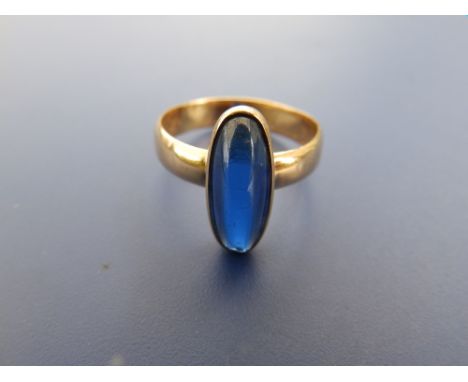 A Swedish 18ct gold ring set with a  slender sapphire cabochon, inscribed to interior of shank and dated '21.11.60'  . Finger