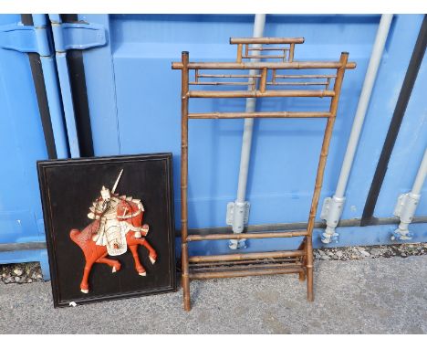 A Japanese wooden panel decorated in high relief carved &amp; stained bone to depict a Samurai on horseback, 20" x 15", toget