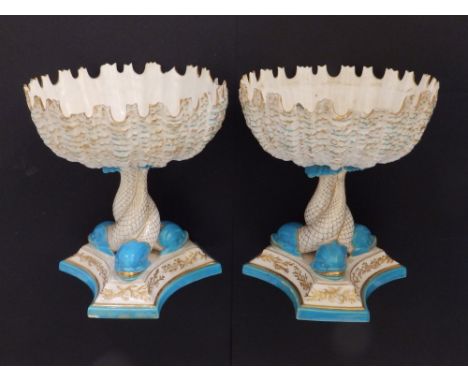 A pair of 19thC Royal Worcester porcelain circular shell-shaped bowls on triform pedestal dolphin bases, decorated in turquoi