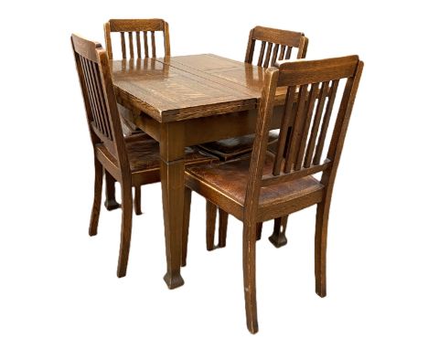 A vintage mid 20th century oak draw leaf dining table and four stick backed dining chairs (5)