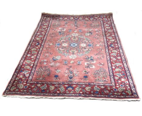 A modern Sarouk style rug, with birds and flowers on a light red field, within a floral border  Dimensions:-  Length - 277cms