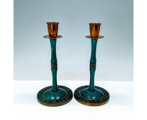 Two heavy brass candle holders, adorned with a Hebrew inscription on the base and green enamel decoration, originating from P