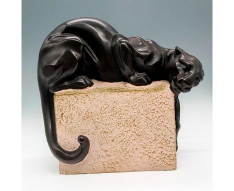 Laying, reaching bronze colored figural on roughhewn block. Signed on base by artist. Austin Productions impressed mark. Arti