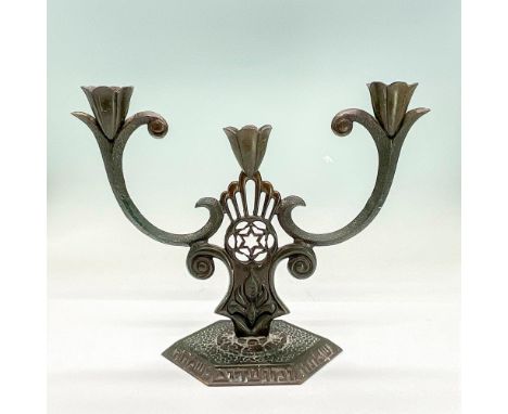 Dark bronze candlestick with three slots. Star of David in the center. Engraved design throughout. Made In Israel on bottom. 