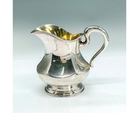 Sterling silver pitcher in flat panel design. Redlich &amp; Co. and Sterling engraved marks. Dimensions: 5"W x 4.25"HManufact