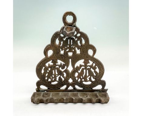 Thick bronze Judaica oil lamp used for Hanukkah with bird and flower motif and eight slots. Dimensions: 6"L x 2"W x 7"HCountr