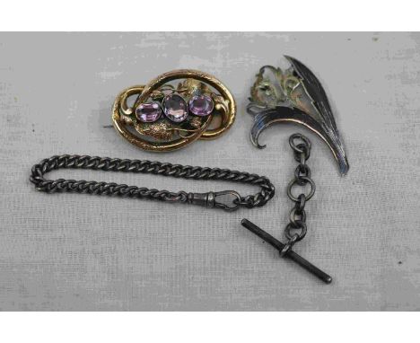 Victorian amethyst pinchbeck brooch, three oval mixed cut set amongst scrolling vine leaves, hinged pin and simple loop brooc