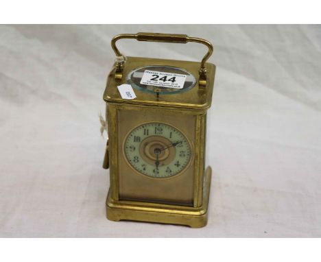 Brass chiming carriage clock, cream enamel dial with gilt centre, black Arabic numerals and black poker hands, height approxi