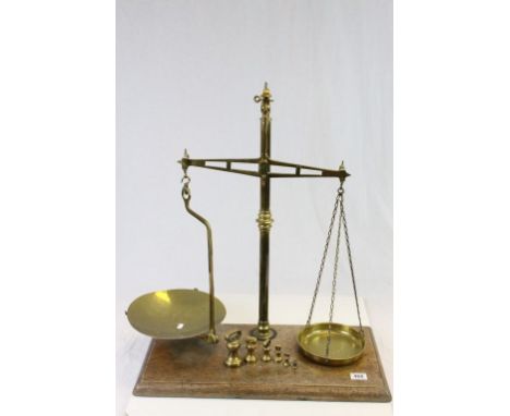 Pair of Avery Brass shop balance Scales with wooden base & Brass weights, the scale pans having Government proof marks