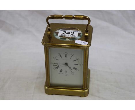 Brass chiming carriage clock, white enamel dial with black Roman numerals with Arabic numerals to outer minute track, black p