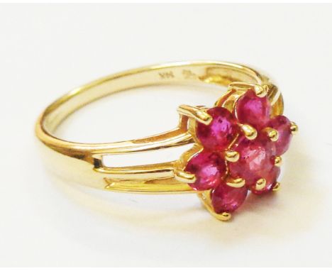 A marked 14k ruby flowerhead ring