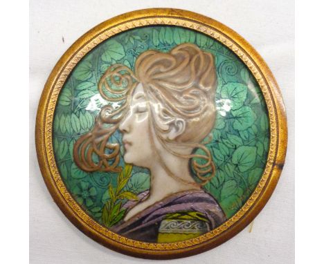 Pierre Bonnaud: An early 20th Century Limoges circular enamel plaque depicting a bust portrait of a young woman against a fol