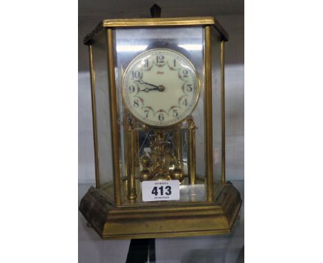 A vintage brass and bevelled glass faceted cased Kundo anniversary table clock with decorative dial and rotary pendulum