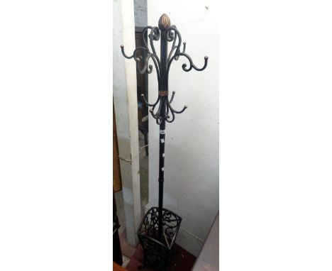 A reproduction ornate wrought iron free-standing hat/coat and umbrella stand with open scroll and parcel gilt decoration