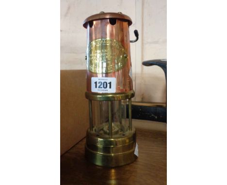 A brass and copper miner's lamp