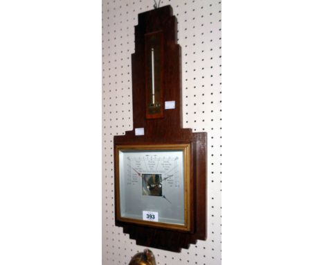 An Art Deco polished oak framed aneroid wall barometer/thermometer with stepped border, brass scale and part faded dial