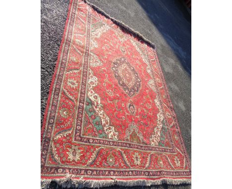 A large carpet with arabesque motif to central medallion and spandrels within a foliate border, light blue and emerald green 