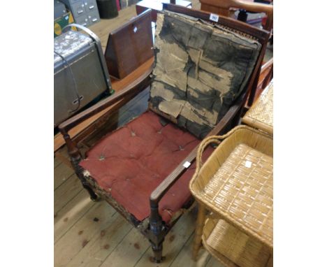 A 19th Century mahogany framed bergere elbow chair with original swabs, reeded rails, semi-reeded front supports and legs wit