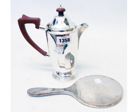 A silver hot water jug of faceted design - sold with a silver backed hand mirror with initials and engine turning