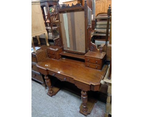 A 3' 11" Victorian mahogany dressing table with swing mirror (plate missing) and flanking trinket drawers over a console base