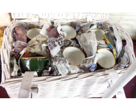 A painted wicker hamper containing a set of six French cups and saucers