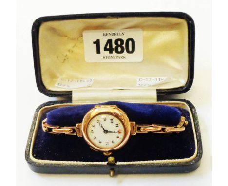 A late 19th Century J. W. Benson watch box containing an import marked 9/375 rose gold lady's wristwatch with enamel dial and